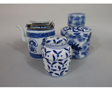 An oriental blue and white caddy of circular form with painted fish decoration, with blue seal mark to base and associated li