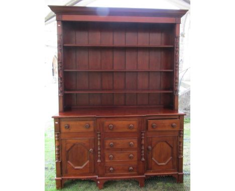Early 19th century provincial breakfront dresser in mixed woods, the central tower of four drawers flanked by two further dra