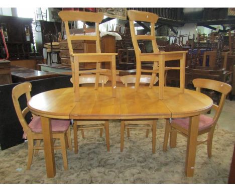 A contemporary light oak D end extending dining table with moulded outline and two additional leaves, raised on square cut su