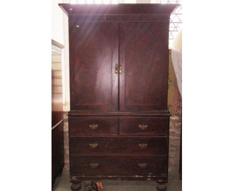 A 19th century mahogany linen press with projecting moulded pediment over a pair of Gothic tracery panelled doors, enclosing 