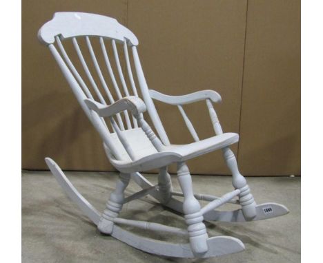 A Boston type child's stick-back rocking chair, with shaped arms, solid seat and turned supports, with later painted finish 