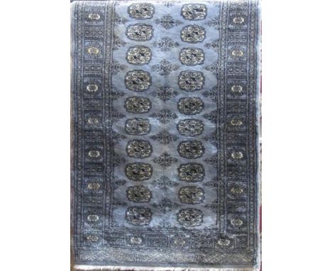 Full pile Bokhara rug with geometric repeating medallion decoration upon a light blue ground, 160 x 90cm 