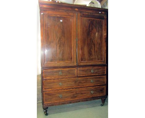 A Georgian mahogany linen press with crossbanding and further inlaid detail moulded cornice over a pair of well matched flame