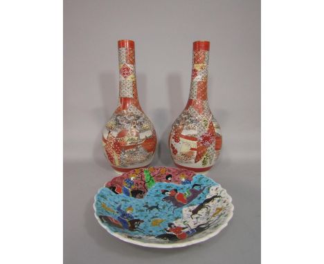 A pair of tall early 20th century Satsuma bottle shaped vases with drawn necks and painted male character decoration and pain