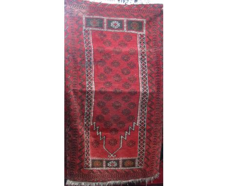 Good Persian rug with geometric floral decoration in an Islamic arched panel, upon a red ground, 160 x 100cm 