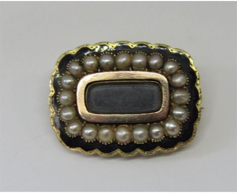 Early Victorian yellow metal mourning brooch with split pearl and black enamel decoration, inscribed verso 'G A Blunt, obiit 