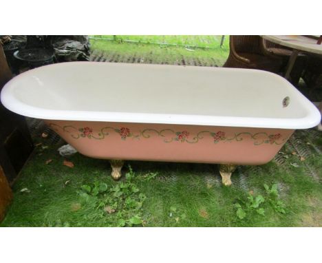 A Victorian cast iron and enamel roll top bath with gilt painted claw and ball feet 