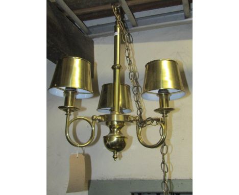 A polished brass hanging ceiling light, the simple knopped tubular stem supporting three scrolled horn shaped branches with f