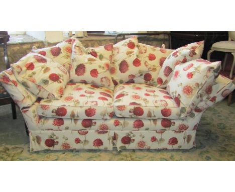 A contemporary but traditional style knoll two/three seat sofa, with drop arms, floral patterned upholstery and loose feather