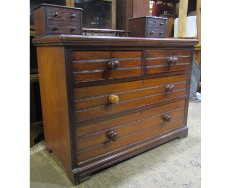 An Edwardian mahogany dressing chest of two long and two short drawers beneath further trinket drawers united by a baluster g