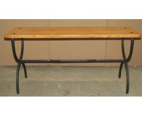 A light oak bench with plank seat and iron work X framed supports, united by a central rail, 94cm long x 28cm wide x 45cm hig