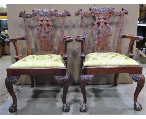 A pair of reproduction Chippendale style mahogany open armchairs, with moulded and scrolled frames, pierced splats and drop-i