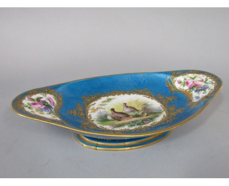 An 18th century Sevres dish of elongated oval form with painted central panel of Partridges in a landscape setting with wheat