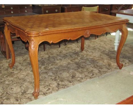 A medium to light oak continental dining room suite comprising draw leaf dining table with serpentine moulded outline and par