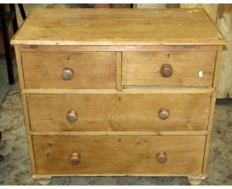 A small Victorian stripped and waxed pine bedroom chest of two short over two long drawers on turned bun feet (AF), 90 cm wid