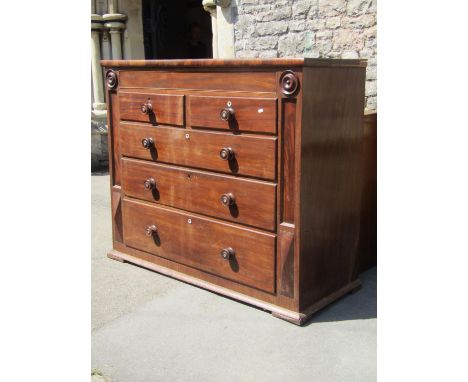 A Victorian mahogany bedroom chest fitted with an arrangement of four long and two short graduated drawers flanked by geometr
