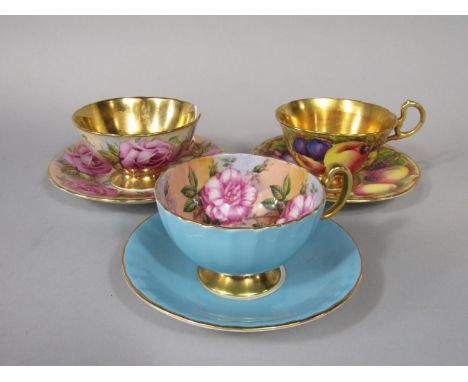 Three Aynsley cabinet cups and saucers, one with fruit decoration in the Royal Worcester style, one with turquoise glaze and 