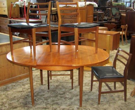 A mid-20th century teak D end extending dining table with single bi-fold leaf, raised on tapered and moulded supports, togeth