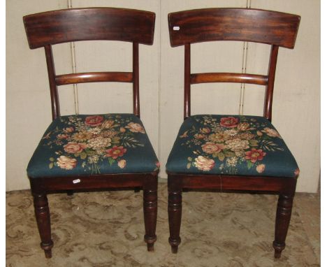 A pair of Chippendale style dining chairs with pierced Gothic tracery splats over drop-in upholstered seats raised on claw an