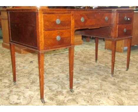 An inlaid Edwardian shallow inverted breakfront knee hole dressing table, with boxwood stringing, fitted with an arrangement 