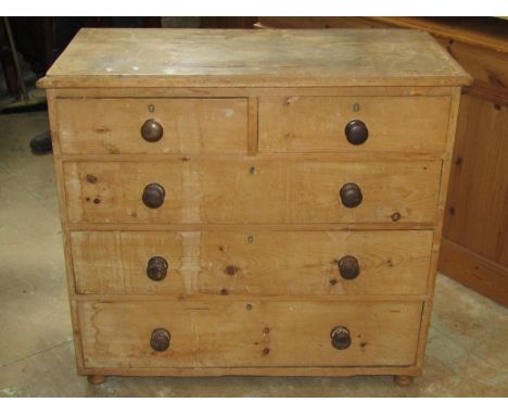 A Victorian stripped pine bedroom chest of two short over three long graduated drawers raised on later associated turned bun 