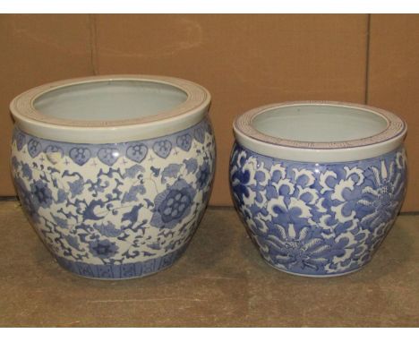 A modern Chinese ceramic blue and white jardiniere/fish bowl with foliate detail, 36 cm in diameter, together with one other 