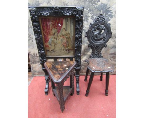 A Victorian carved oak fire screen with applied trailing floral rams mask, cherub and other panels (possibly earlier) raised 