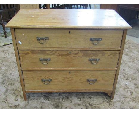 A small late Victorian stripped pine bedroom chest of three graduated drawers, with cast brass loop drop handles, 92cm wide x