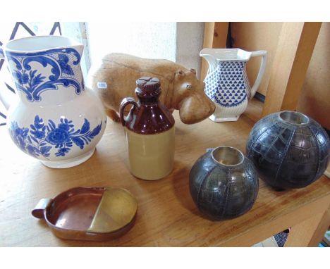 A mixed lot to include a carved treen wooden Hippo, pair of stitched leather clad tea light holders, a Scrumpy Jack cider fla