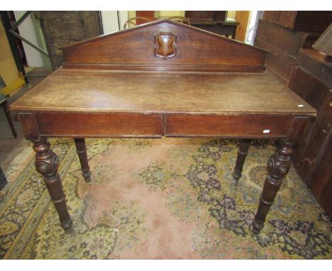 Mid-Victorian oak serving table of rectangular form, enclosing two frieze drawers, raised on four turned and tapering support