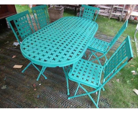 A contemporary green painted light steel D ended garden terrace table and five matching folding chairs with decorative pierce