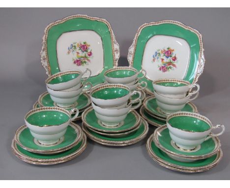 A collection of Paragon China green ground tea wares with printed pheasant and floral detail comprising a pair of cake plates