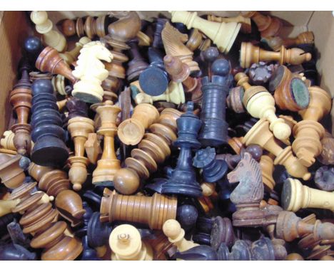 A large unsorted collection of miscellaneous traditional chess pieces, principally in box wood ebony 