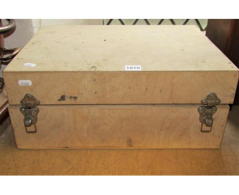 A plain wooden box containing leather workers tools 
