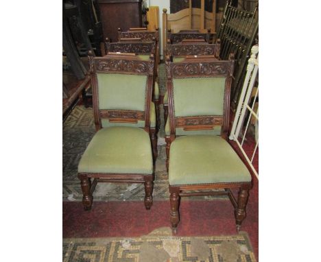 A set of six Victorian oak dining chairs with sage green dralon upholstered seats and back pads within carved and moulded fra