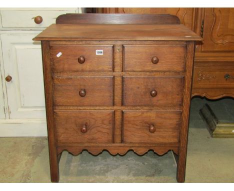 A small good quality oak bedroom chest of three long graduated drawers disguised as six small, raised on square cut and mould