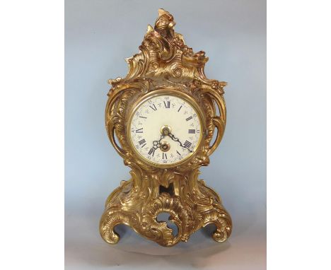Rococo style gilt cast metal single train mantle clock, painted with Roman numerals, quartz movement, 40cm high 