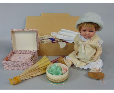 A Heubach Koppelsdorf 320 character baby doll C1920 with bisque head, blue sleeping eyes, jointed bent limbs, 44 cm tall and 
