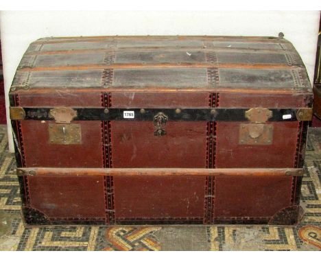 A large vintage timber lathe and steel banded domed top trunk with studded initials to lid GL, together with one other smalle