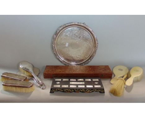 Three hallmarked silver backed brushes, a further hallmarked mirror, a silver plated serving tray with chased detail, a paral