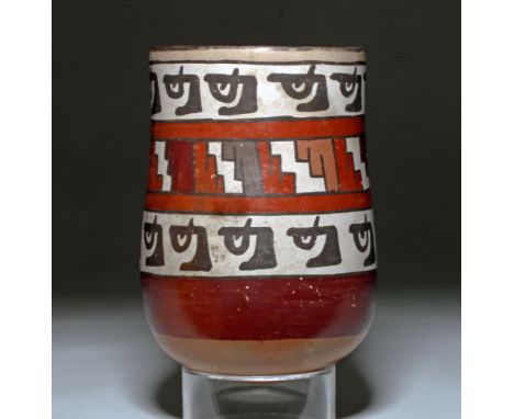 Pre-Columbian, South Coast Peru, Nazca, ca. 400 to 500 CE.  A polychrome beaker hand-built from a rounded bottom, resolving i