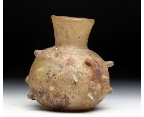 Middle East, ca. 700 to 1000 CE. Small glass jar with a bulbous body, made of clear glass that has aged to a yellow tint. It 