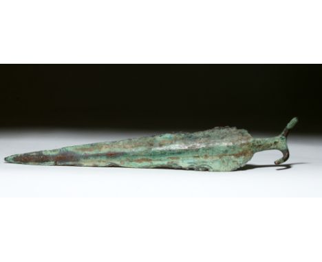 India, early Vedic Period, ca. 1500 to 1200 BCE. This is a large copper dagger with an "antennae" style pommel and a prominen