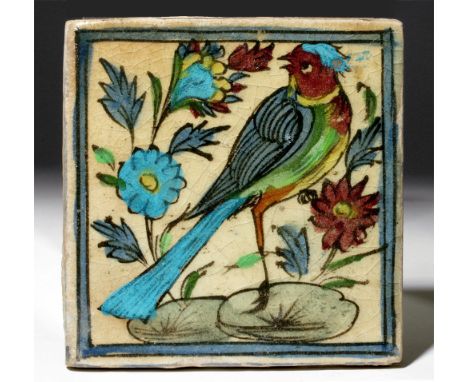 Iran, 19th century CE. This is a square tile with glazed artwork of a brightly colored bird and flowers; blues and purples ar