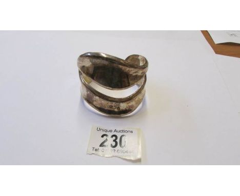 An art deco style silver bangle, 74 grams.