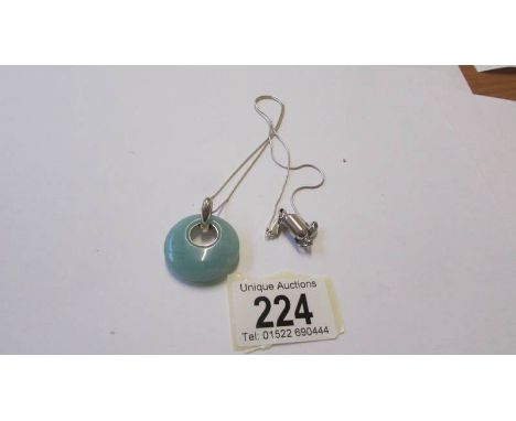 A silver and jade pendant.