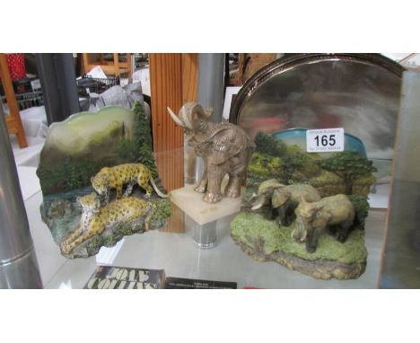 Two elephant figures (one trunk off) and a leopard figure.