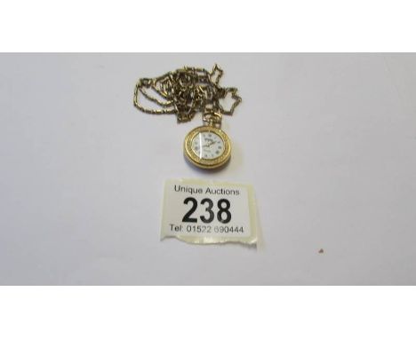 A gilded pendant watch with enamel style back and front, Swiss made, Bernex.&nbsp; In working order.