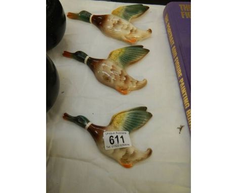 A set of three ceramic flying ducks.&nbsp;