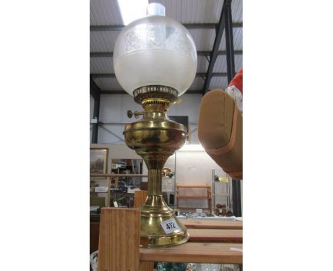 A brass oil lamp with shade. COLLECT ONLY.